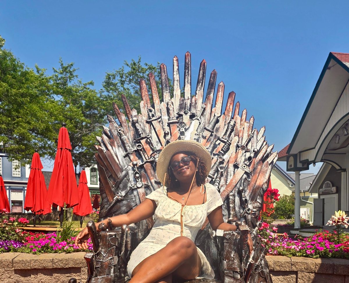 Cynthia sitting on an iron throne sculpture